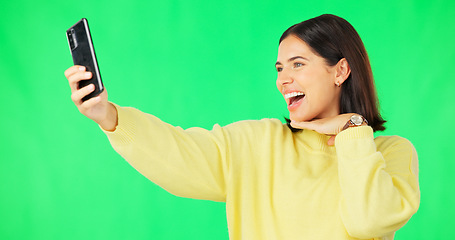 Image showing Happy woman, face and selfie on green screen with peace sign and facial expressions against studio background. Silly or goofy female model smiling for photo, emoji or memory with smartphone on mockup