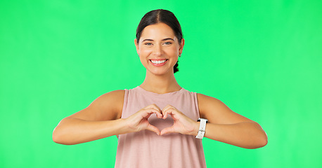 Image showing Heart, hands and face of happy woman on green screen for fitness, wellness or healthy life. Female portrait, sports model and finger shape of love, support and motivation for care, emoji sign or icon