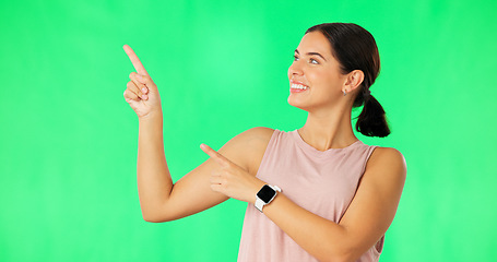 Image showing Woman face, hands pointing and green screen with happiness and smile showing advertisement. Portrait, isolated and studio background with a happy young female point to show mock up announcement