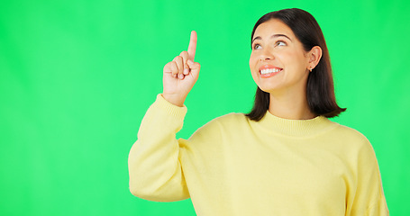 Image showing Portrait, point and branding with a woman on a green screen background in studio for marketing or product placement. Hand gesture, advertising and options with an attractive young female on chromakey