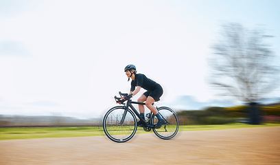 Image showing Cycling, motion blur and fitness with woman in nature and mockup for speed, workout and challenge. Exercise, fast and travel with female cyclist riding on bike for journey, adventure and cardio