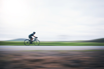 Image showing Person cycling fast with motion blur, sky mockup and bike in countryside, triathlon and cardio training. Athlete, bicycle and marathon race with speed, energy and sports for exercise, power or action