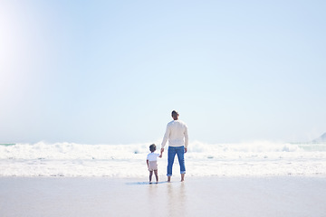 Image showing Father, son and beach with back, space and mock up with blue sky, lens flare and bonding with love in summer. Papa, male kid and holding hands for care, vacation and sea mockup with waves in sunshine