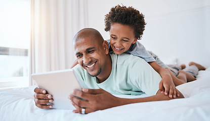 Image showing Happy father, child and watching on tablet in bed for fun streaming or entertainment together at home. Dad, son or kid with smile relaxing with technology for movie, series or education in bedroom