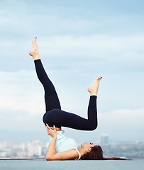 Image showing Fitness, yoga and woman on roof in city, stretching legs and back for wellness and balance with healthy body. Health care, pilates and mindfulness, zen workout for girl and view of cityscape rooftop.