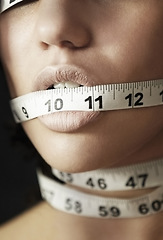 Image showing Anorexia, measuring tape and suffering with mouth of woman for eating disorder, weight loss and fear. Diet, frustrated and mental health with closeup of female for anxiety, stress and bulimia problem