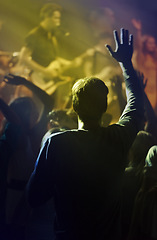 Image showing Concert, singing and people dancing to music at night performance, rock and gen z singer in lights and cheers. Musician on stage at disco event and fans rear, crowd or audience with man hands in air