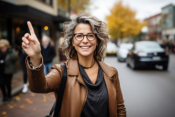 Image showing Woman with glasses hailing taxi