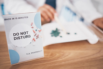 Image showing Employee break sign, pharmacy and shop poster closeup of an busy board in healthcare store. Medical, wellness and doctor practise with a do not disturb placard and billboard on worker desk at clinic