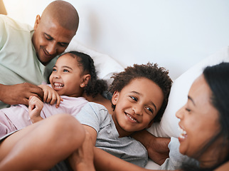 Image showing Happy family, relax and playing in the morning on bed with smile for free time, weekend or fun holiday at home. Mother, father and children relaxing and laughing together for playful joy in bedroom