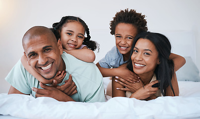 Image showing Portrait, family and smile in home bedroom, bonding and relaxing or lying together. Bed, happiness and children with mother and father or parents enjoying quality time, having fun and care in house.