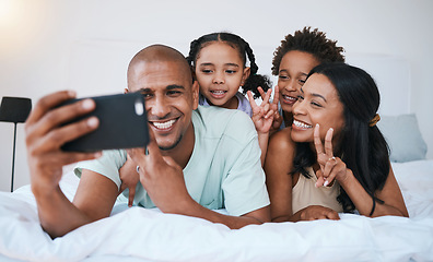 Image showing Selfie smile, family and peace sign in bedroom, bonding and relaxing together in home. Bed, photo and children with mother and father taking pictures for happy memory, social media or v hand emoji.