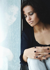 Image showing Sad, rain and crying with woman by window for depression, tired and lonely. Anxiety, mental health and exhausted with female thinking at home for broken heart, disappointed and fear mockup