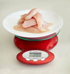 Image showing Protein, nutrition and chicken breast on a scale in studio from above on a table in the kitchen for health or wellness. Food, meat and diet with healthy organic lunch on a plate to measure the weight