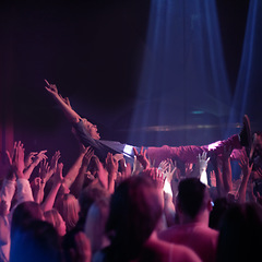 Image showing Crowd surf, people at music festival or rock concert, neon lights and energy at live show event. Support, fun and group of excited fans in arena at band performance and person on hands of audience.