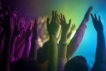 Image showing Hands, neon and lighting for people at concert dancing, music festival or crowd with energy at night event. Dance, fun or group of excited fans in arena, rock band performance and disco color party