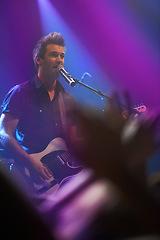 Image showing Music, singer and man with guitar at concert, event or show for performance. Rock, festival and male musician with electric musical instrument, live or rockstar singing on stage for crowd of fans.