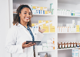 Image showing Digital tablet, portrait and woman pharmacist in a medication dispensary at the medicare clinic. Happy, smile and female pharmaceutical healthcare worker with a mobile device by medicine in pharmacy.