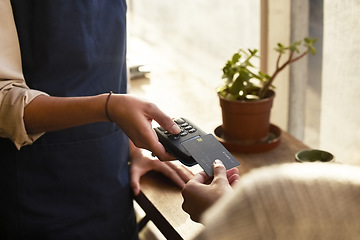 Image showing Hand, credit card and pos terminal in a coffee shop for payment by a customer to a waitress for service. Finance, bill and nfc with a person paying using wireless technology in a cafe or restaurant