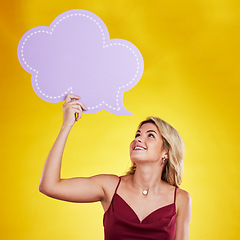 Image showing Smile, looking and woman with speech bubble in studio isolated on a yellow background. Poster, word cloud and happy female person holding advertising banner for marketing, opinion or social media.