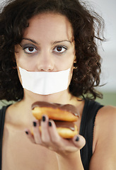 Image showing Portrait, anorexia and woman with donut and tape over mouth to stop eating, unhappy and delusional. Face, covering and face of female suffering eating disorder, body dysmorphia or bulimia problem