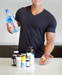 Image showing Closeup, fitness and man with pills, water bottle and healthy lifestyle for wellness, balance and vitamins. Zoom, male person and bodybuilder with liquid, health and exercise with supplements at home