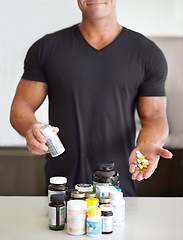 Image showing Healthy, showing and man with pills for training, fitness energy and muscle gain. Diet, drugs and an athlete taking a supplement for sports, body builder protein and drugs for exercise at home