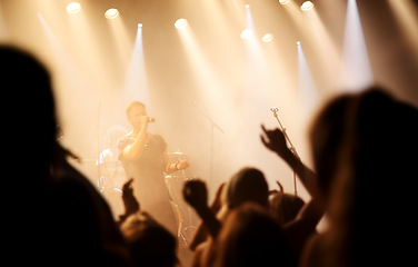 Image showing Music festival, concert or people singing at night performance for gen z party, nightclub lights and dancing. Rock band on stage at event with crowd dance, audience group or fans energy in silhouette