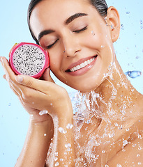 Image showing Dragon fruit, water or happy girl with beauty in studio on blue background for healthcare or vegan diet. Smile, fruits or healthy woman model face with wellness or vitamin c for skincare or detox