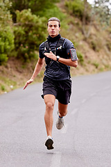 Image showing Running, fitness and portrait of man runner for outdoor training or exercise goals, challenge and sports health in nature. Young, fast and speed of serious athlete in cardio workout on road or street