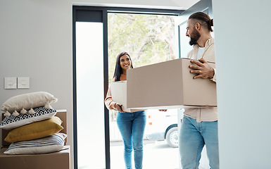 Image showing Couple moving, new house and carrying boxes with property, man and woman in real estate as homeowners. Mortgage, happy with move and walk in front door, partnership and people smile with relocation