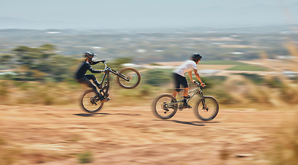 Image showing Mountain bike, men and race with speed, dirt and nature in summer with wheelie, extreme sport and motion blur. Friends, bicycle and outdoor challenge for fast workout, training and exercise in summer