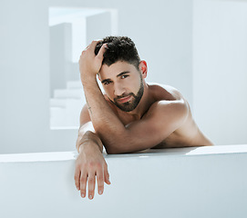 Image showing Handsome, building and shirtless man outside in a modern bathroom for creativity and commercial model. Guy, body and artistic person relax, young and calm in a white room relaxing or chilling