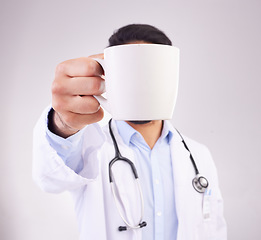 Image showing Hand, coffee and doctor in studio for break, relax and morning routine against grey background. Healthcare, tea and man with drink, beverage and cup while working at hospital or clinic isolated