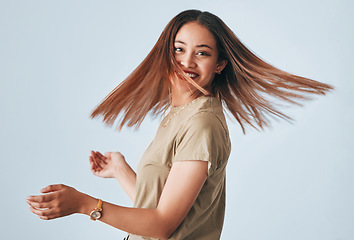 Image showing Portrait, beauty and hair with a woman in studio on a gray background for keratin treatment or haircare. Salon, shampoo and hairstyle with an attractive young female posing to promote natural care