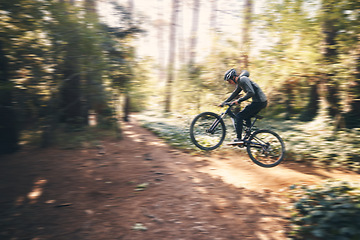 Image showing Cycling, jump and fast with man in nature for adventure, fitness and extreme sports. Workout, exercise and speed with male cyclist on bike in forest park for action, performance and training