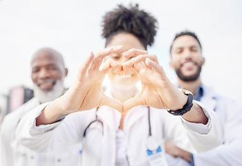 Image showing Heart hand, happy and portrait of doctors in the city for healthcare, medical attention and care. Smile, medicine and hospital workers showing love with emoji hands for professional nursing as a team