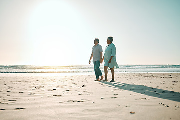 Image showing Sunset, mockup and an old couple walking on the beach, holding hands during a romantic date together. Love, nature or bonding with a senior man and woman taking a walk on the coast during summer