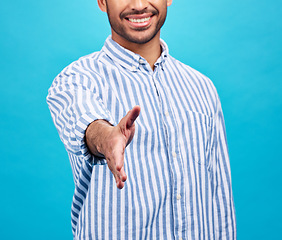 Image showing Handshake, interview and hand of businessman on blue background for thank you, welcome and deal. Recruitment, hiring sign and male person shaking hands for opportunity, agreement or studio onboarding