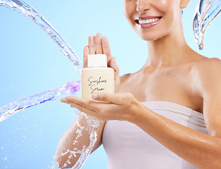 Image showing Woman, hands and water splash for skincare serum, product or cream against a blue studio background. Hand of happy female smile holding moisturizer creme for beauty cosmetics or facial treatment