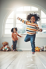 Image showing Hopscotch, games and children play in home having fun, enjoy entertainment and relax together in room. Childhood, happy and excited siblings in bedroom for jumping game, playing and activity on floor