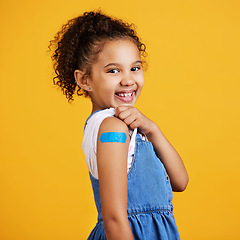 Image showing Portrait plaster and girl with smile, confidence and vaccination against a studio background. Face, Latino female child and happy young person showing injection, happiness and cheerful on backdrop