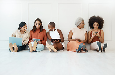 Image showing Group, business and women on the floor, technology or focus for connection, social media or planning. Female employees, coworkers or staff on ground against a wall, office or device for data analysis