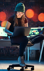 Image showing Laptop, woman and hacker typing in home for programming, software or cybersecurity. Smile, computer and happy female coder or it programmer with ransomware for hacking while on dark web at night.