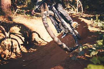 Image showing Cycling, closeup and wheel with man in nature for fitness, training and adventure. Extreme sports, speed and cardio with male cyclist on bike in forest park for travel, challenge and performance