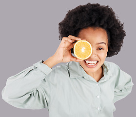 Image showing Portrait, orange and black woman smile with fruits in studio isolated on a gray background. Food, top view and happiness of person with vitamin c, nutrition or healthy diet, citrus or vegan detox.