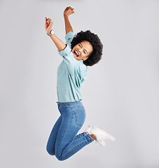 Image showing Excited, jump and black woman with success in studio with winning, achievement and celebration for good news. Winner, mockup and isolated girl on white background jumping for prize, promo and bonus