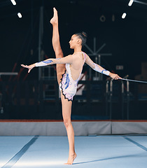 Image showing Ribbon, gymnastics and flexible woman in dance performance, balance legs and sports competition. Female, rhythmic movement and flexible dancing athlete, action and talent of creative concert in arena