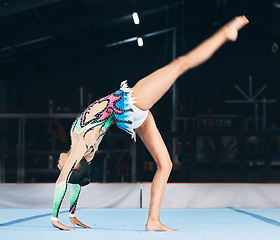 Image showing Woman, gymnastics and handstand for flexible performance, body stretching and dance in sports arena. Female, rhythmic movement and balance upside down in talent show, competition or agility challenge