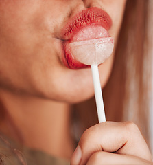 Image showing Lollipop, woman and mouth closeup with makeup, cosmetic and beauty while eating sweet candy. Lips, young person and hungry female model with a girl pout with sweets and cosmetics for youth aesthetic